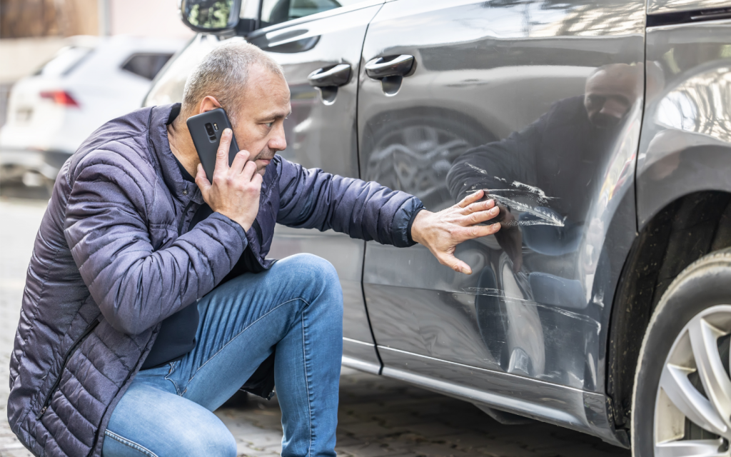 A driver calling authorities to report an accident 