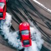 Two red cars drifting