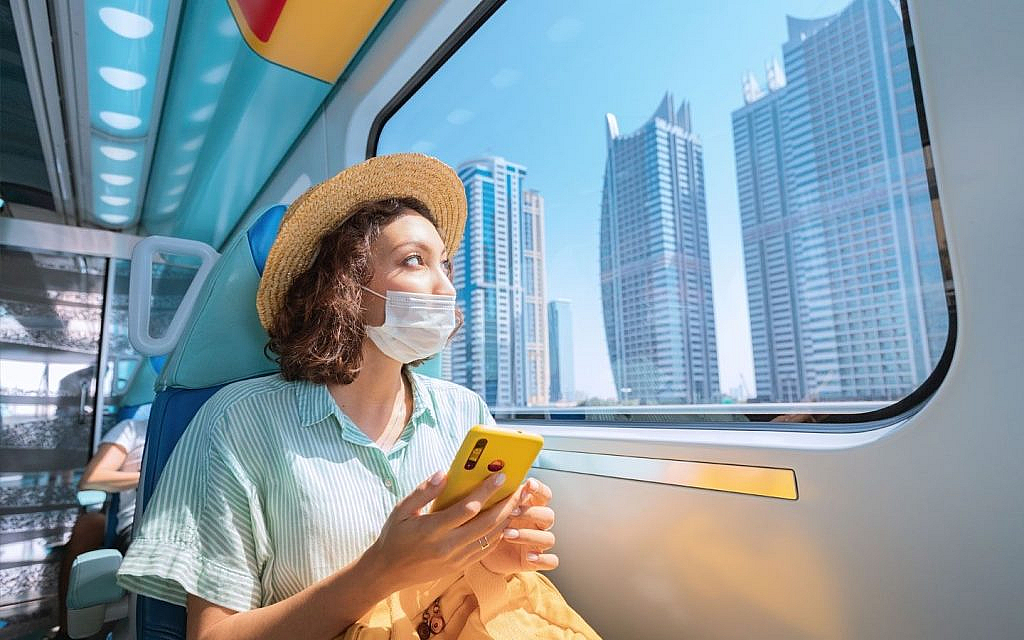 A women comfortablly travelling through metro