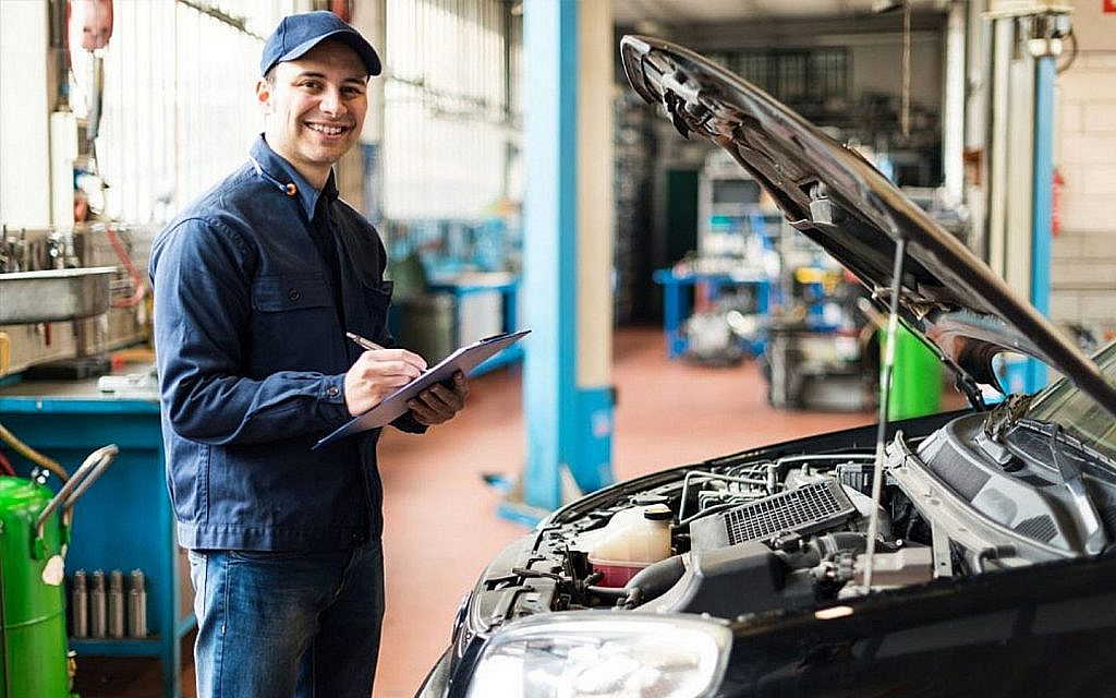 Car owner getting it repaired by a professional mechanic