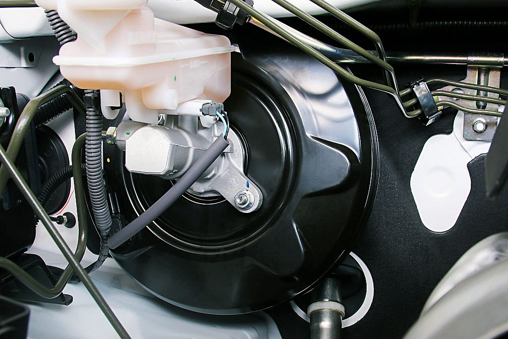 Park your car on smooth surface to replace brake booster