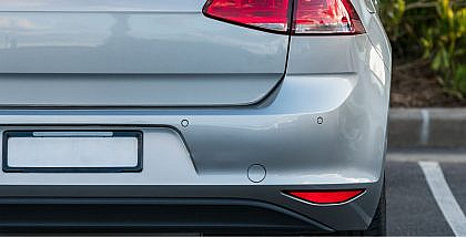 Silver Volkswagen Golf rear view with parking sensors.
