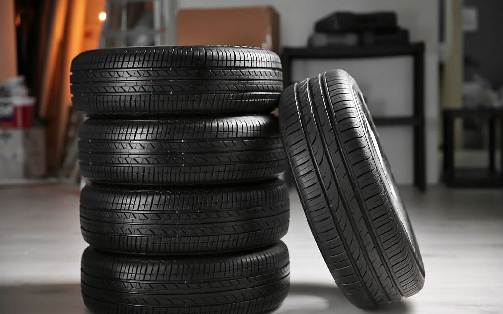 A stack of tyres neatly piled on top of one another.