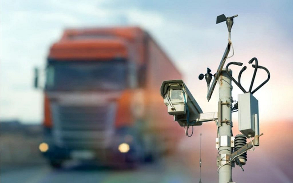 A traffic camera focusing on turck on the highway
