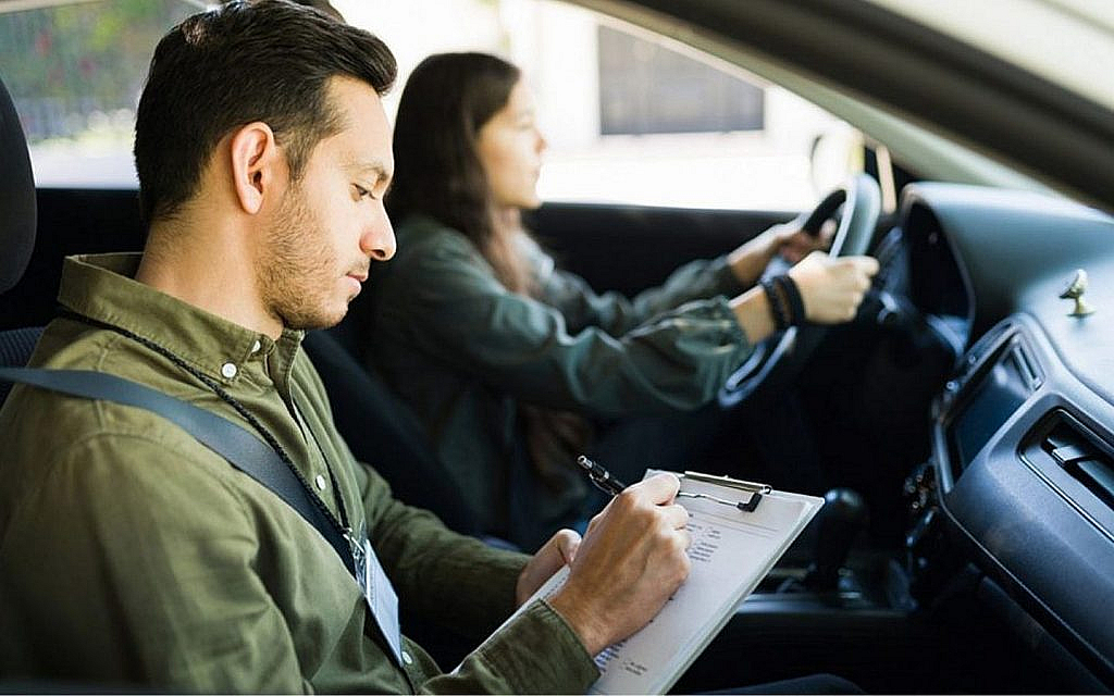A student and driving instructor in a car