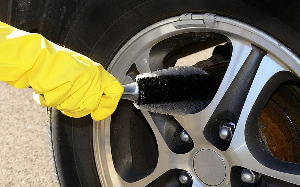 Man using a brush on wheels
