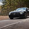 A Mercedes-Benz car is driving smoothly on a rough road.