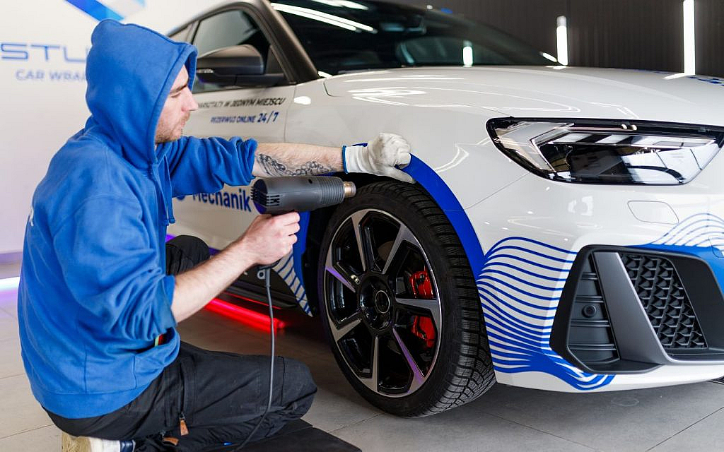 Car wrapping in progress for colour change and protection.