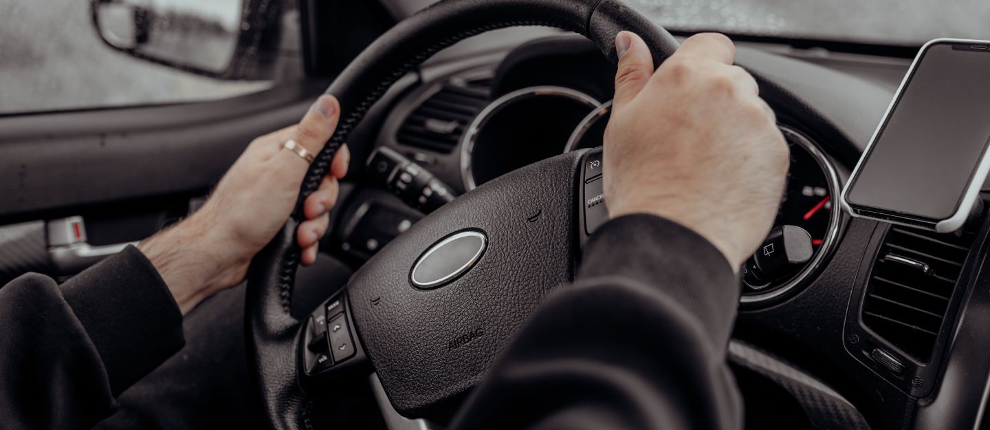Car interior showing steering wheel misalignment – off-center steering wheel causes and fixes.