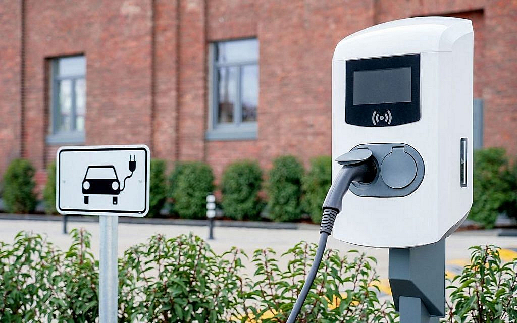 A fast charger in RAK with EV charging sign next to it