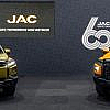 Display of JAC electric and hybrid vehicles at an auto show, highlighting innovation and facts about JAC Motors.