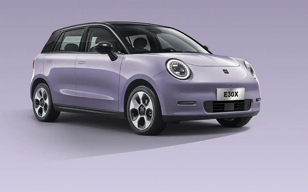 A purple JAC car is displayed indoors with a sleek design and modern features.