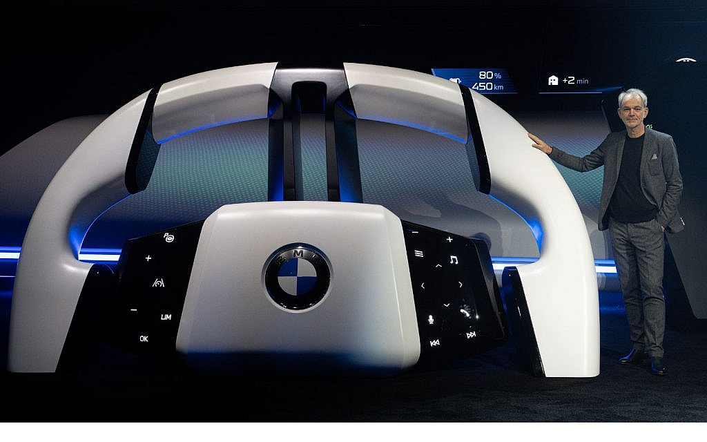 Adrian van Hooydonk is presenting the BMW Panoramic iDrive steering wheel. 