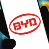 A hand holds a smartphone displaying the BYD app