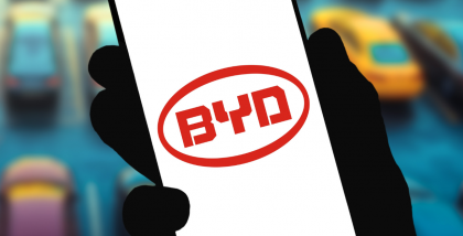 A hand holds a smartphone displaying the BYD app