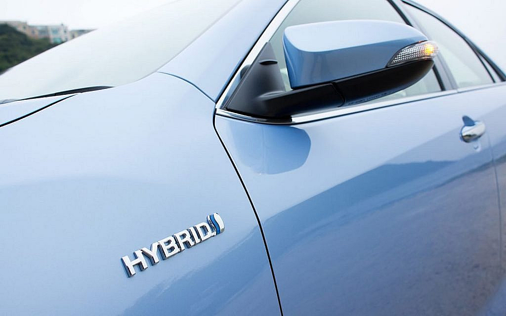 hybrid monogram on the fender of a blue car