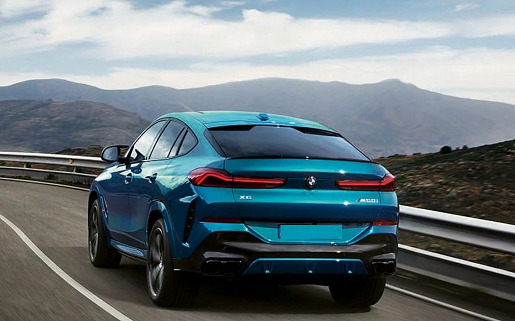 latest BMW X6 on a hilly road 