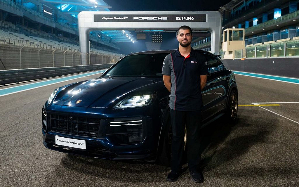 Ramez Azzam standing with the Porsche Cayenne Turbo GT SUV.
