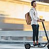 a boy riding an electric scooter in an urban area, reflecting the safe commuting goals of the RTA Personal Mobility Monitoring Unit.