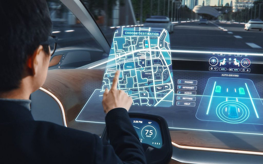 A businessman is interacting with a futuristic digital screen to set a navigation location in a self-driving car. 