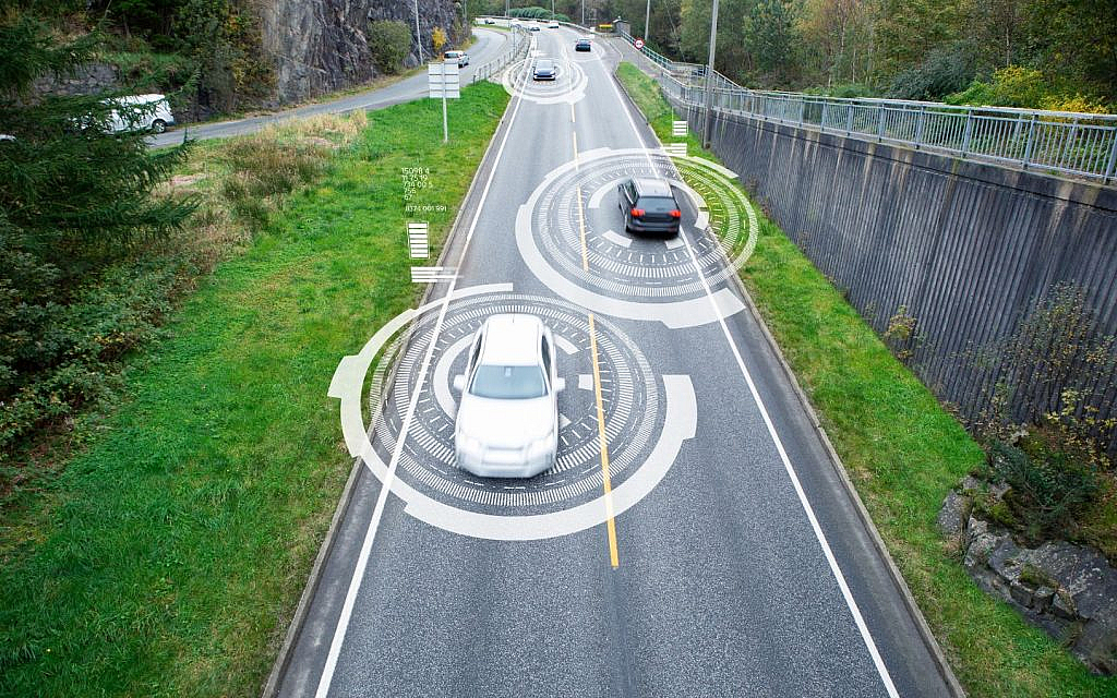 A graphic illustration showing data communication and information exchange between connected vehicles on a road 