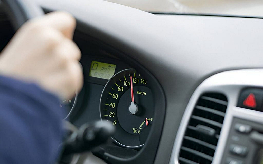 A car speedometer showing overspeeding