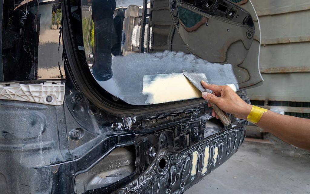 Use light filler for small dents, reinforced for deep ones.