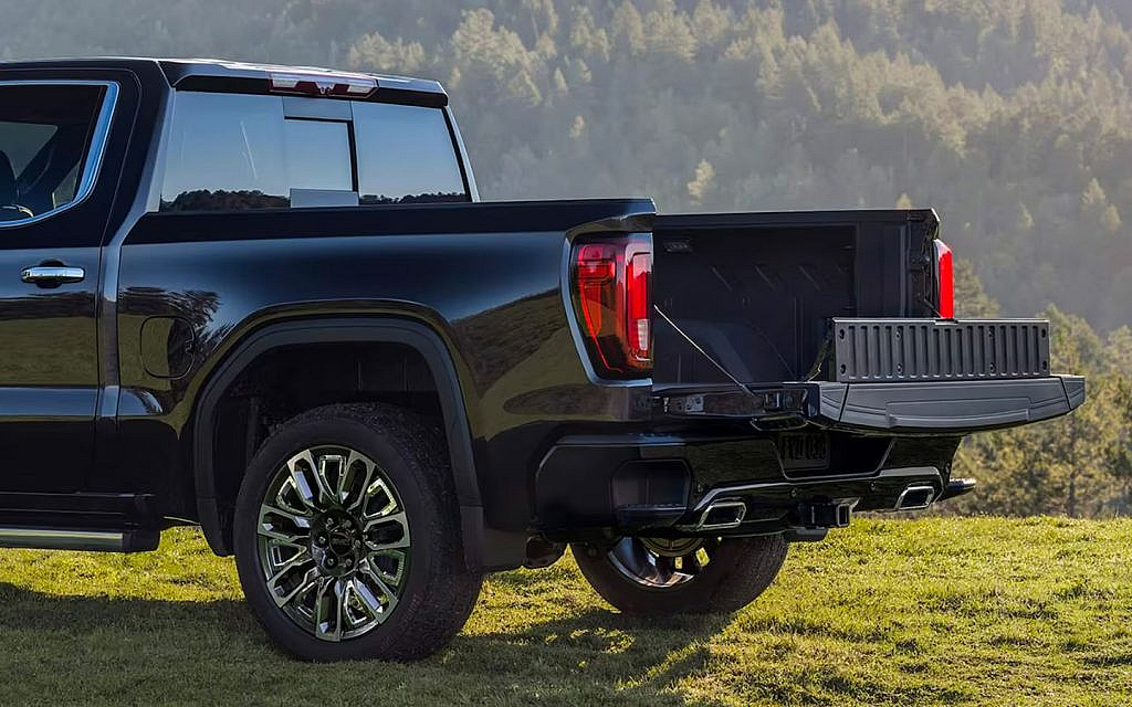 rear power tailgate of the latest GMC Sierra standing on a hilly area