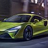 Vibrant lime green McLaren Artura sports car driving, highlighting interesting facts about the McLaren Artura.