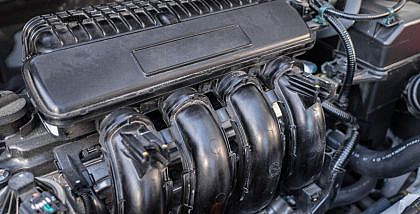 Close-up view of V16 engine's manifold and engine cover.