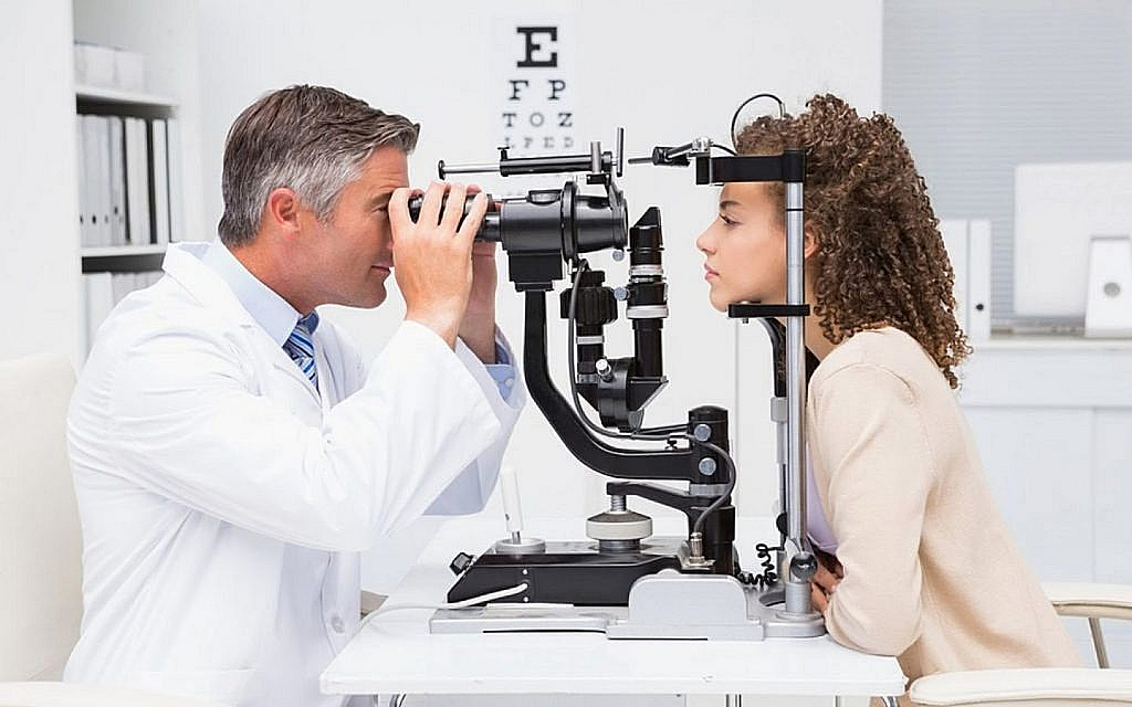 An optician checking the eyesight of a driver