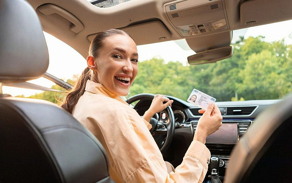 A woman celebrating after getting a driving licence