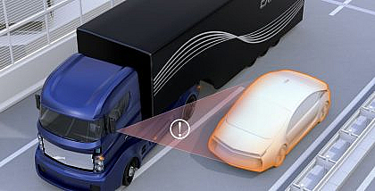 Blue truck and orange car in a near-collision, representing a Side Collision Warning System.