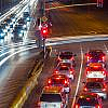 Night traffic with light trails on a busy Dubai road, related to the Dubai Traffic Safety Strategy.