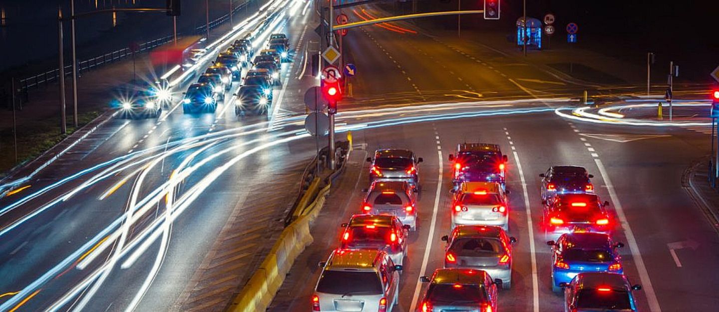 Night traffic with light trails on a busy Dubai road, related to the Dubai Traffic Safety Strategy.