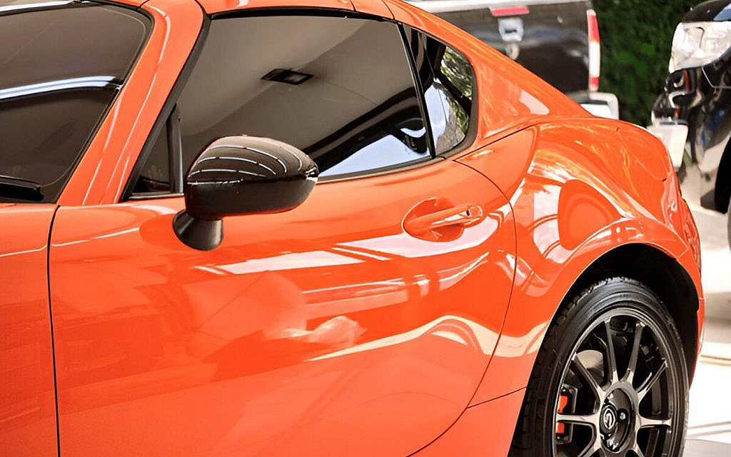 A laminated glass fitted on an orange sports car