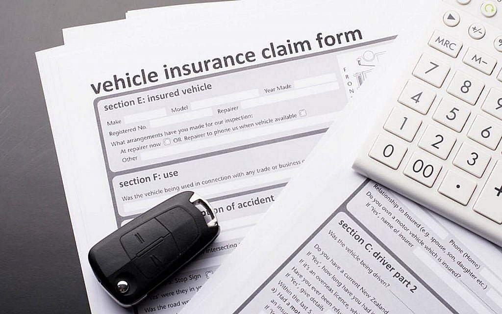  Vehicle insurance claim form with a car key and a car key on top.
