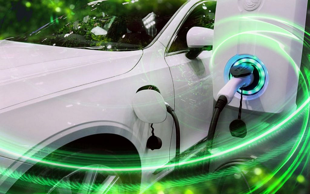 An white colour EV is plugged into a charger