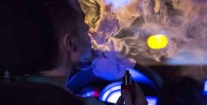 man vaping in car