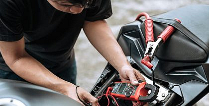 a person installing a motorcycle GPS tracker