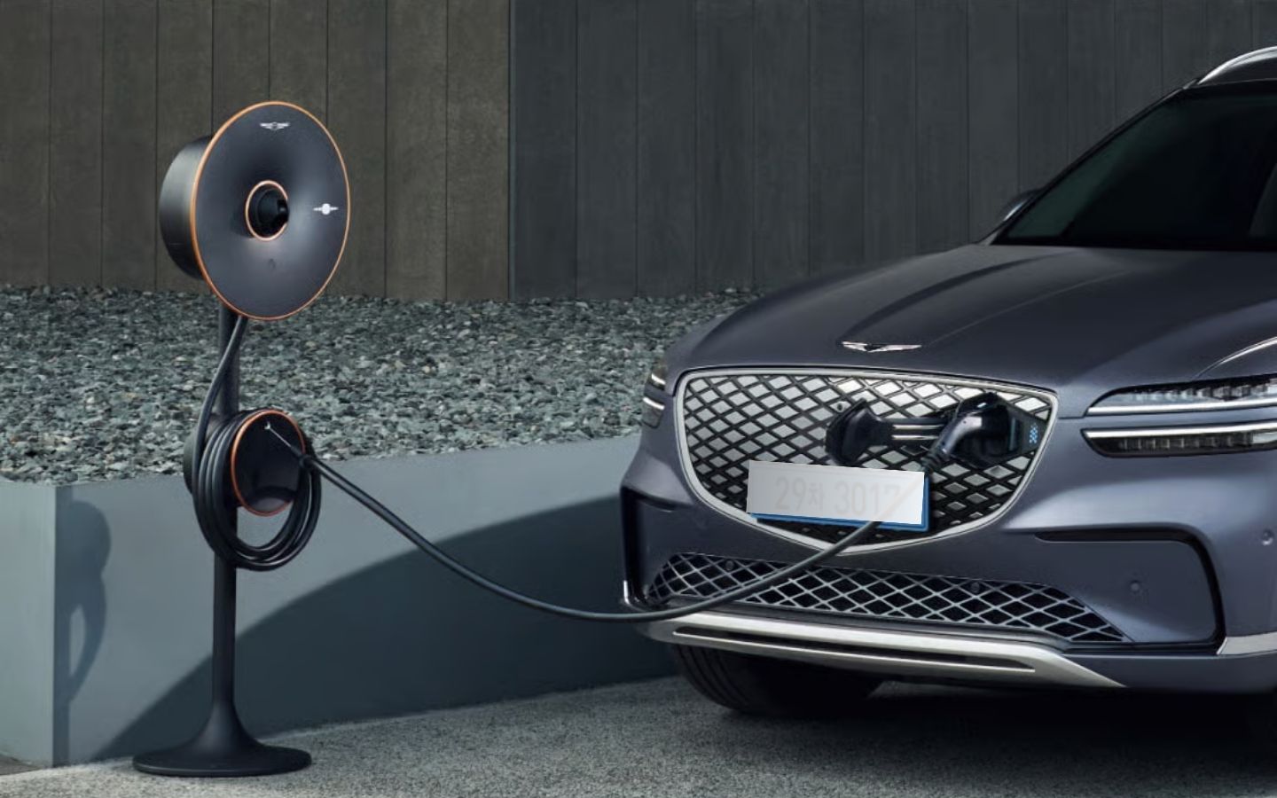 Electrified Genesis GV70 plugged into a charger
