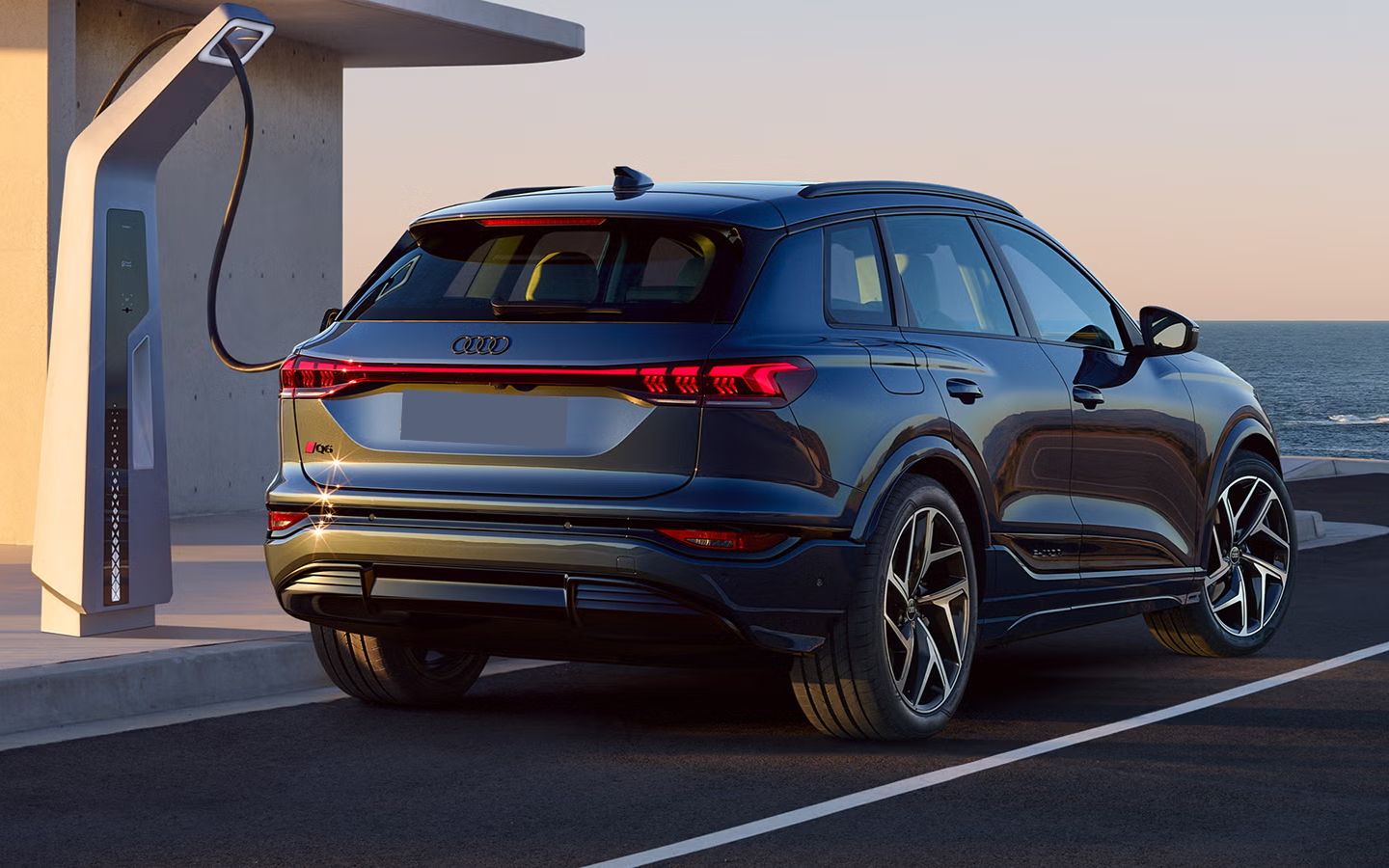 Grey Audi Q6 SUV plugged into a charger