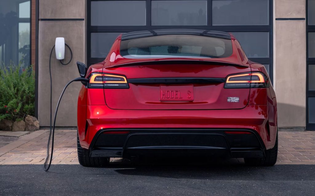 Red Tesla Model S charging at home