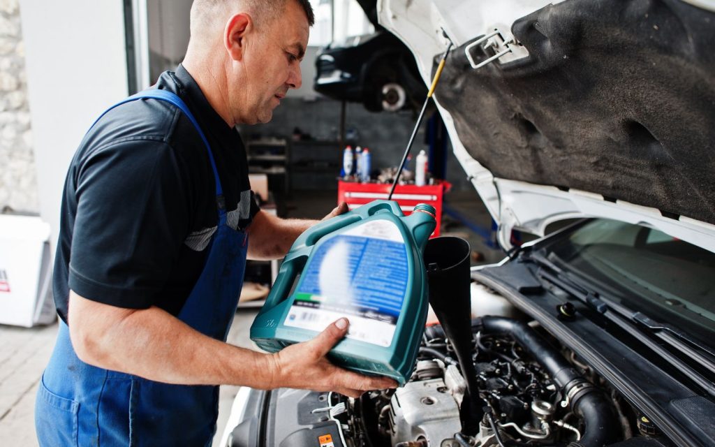 a mechanic changing the brake fluid of a car
