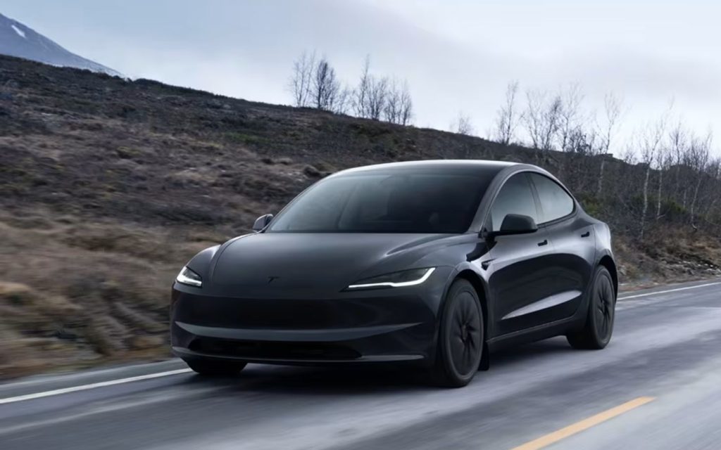 The Tesla Model 3 sports a sleek, aerodynamic design with a glass roof.