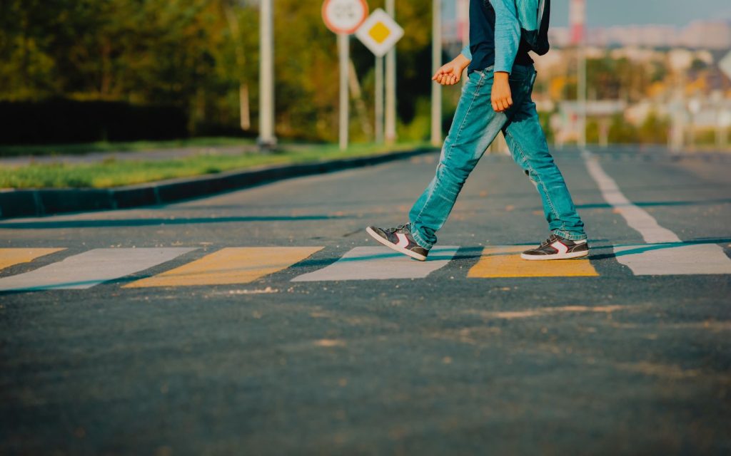 Early road safety education teaches children essential habits like stopping, looking both ways, and recognising traffic lights