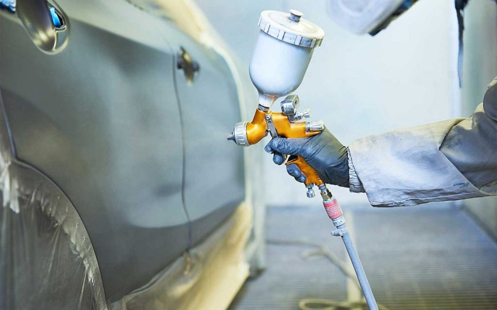 A mechanic repairing a car