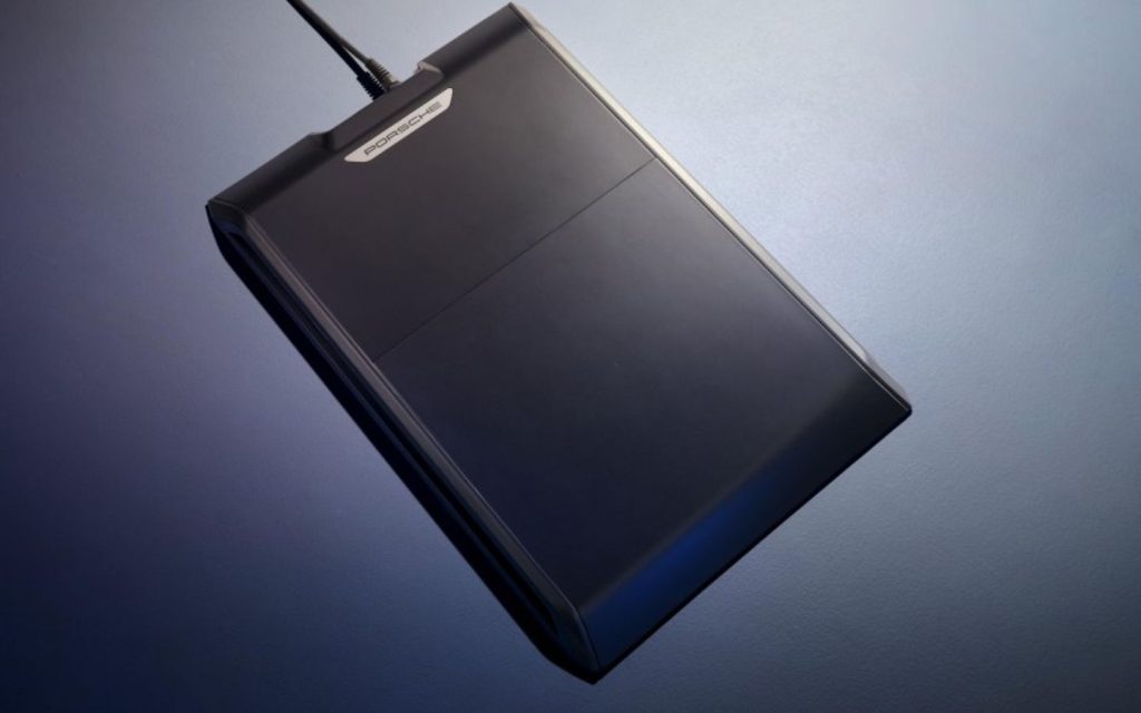 A wireless EV charger for Porsche vehicles is installed on the ground