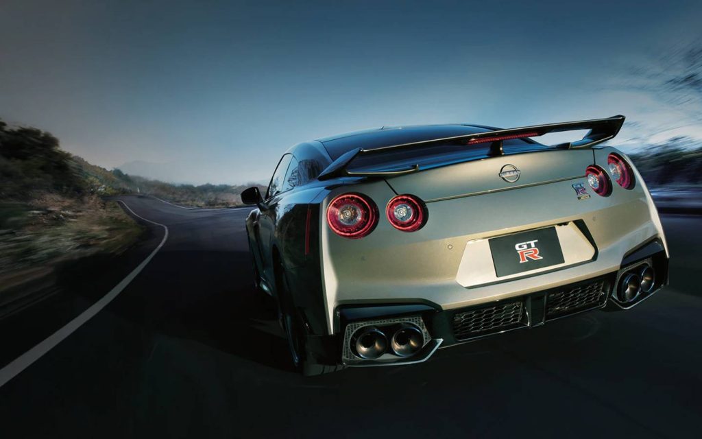 rear end of nissan gtr speeding on a country road