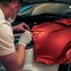 A mechanic is applying different types of car wraps